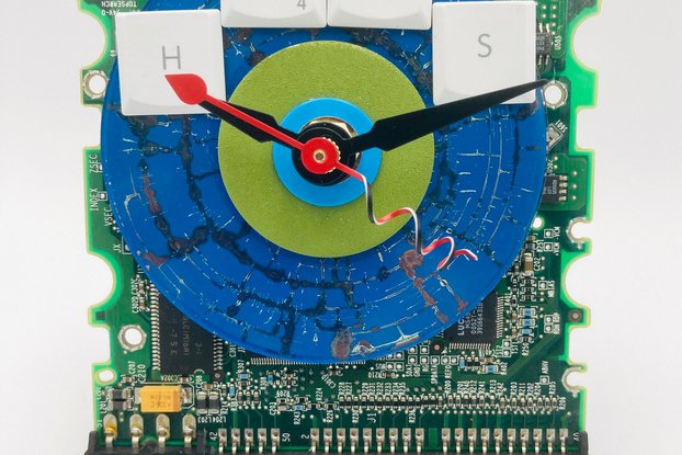 HUGS CD on circuit board clock, blue, green tones